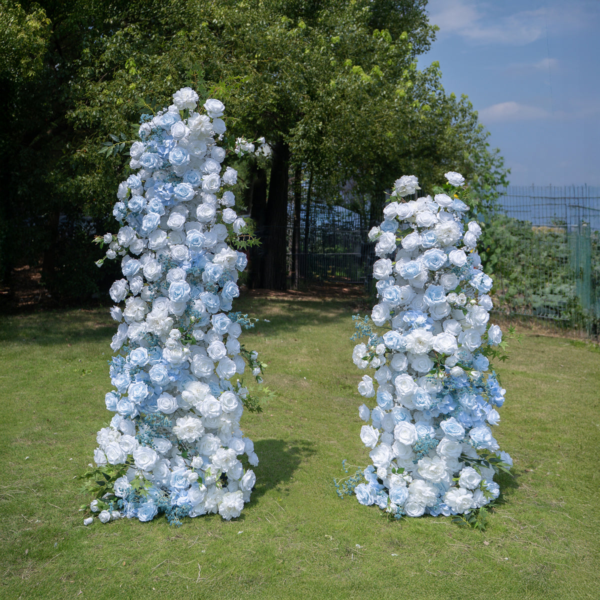 Aquella blue and white floral pillar wedding arch, front view